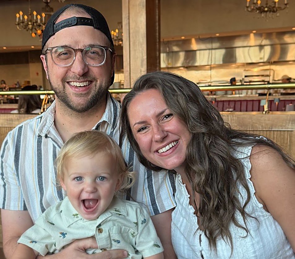Jon, his wife Katherine, and their son Leo smiling together